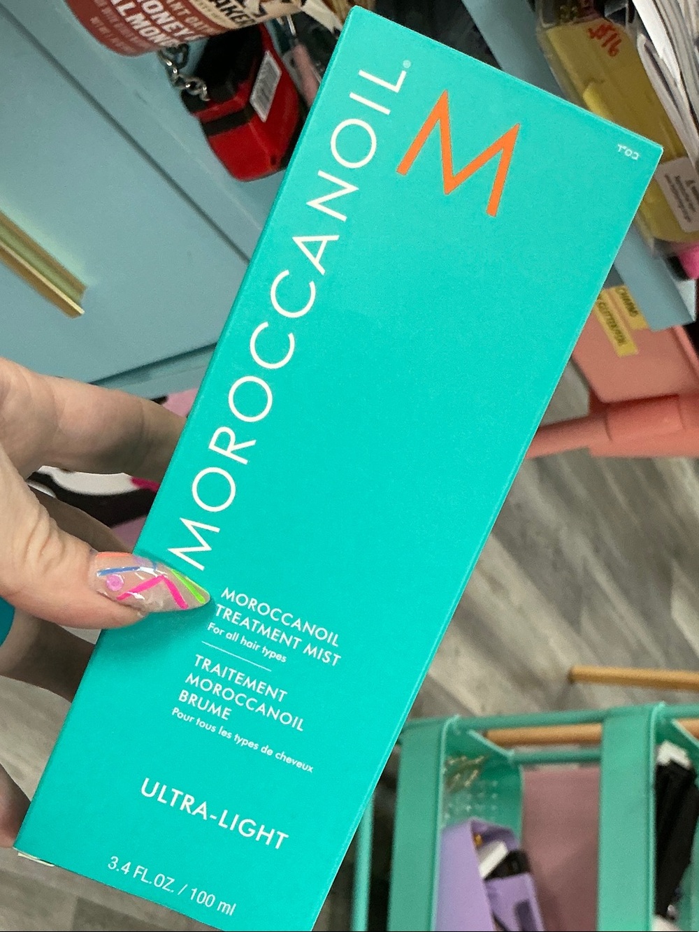 Moroccanoil Ultra-Light Treatment Mist in turquoise with orange logo 3.4 fl oz